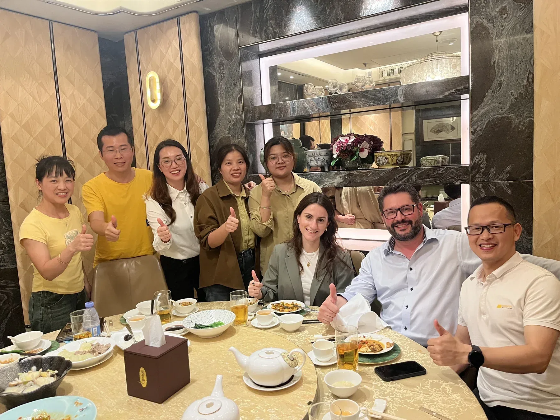 NaikeCraft colleagues sharing dinner with international visitors after a meeting